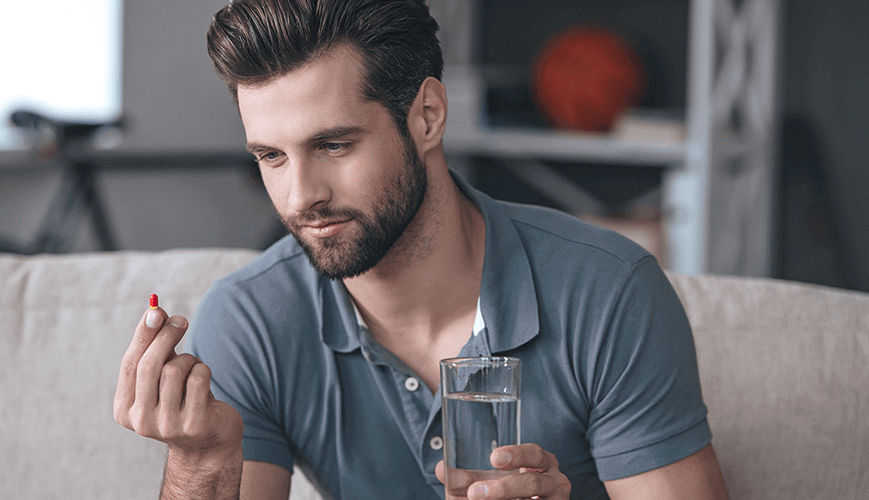 Man thinking about taking pain medication